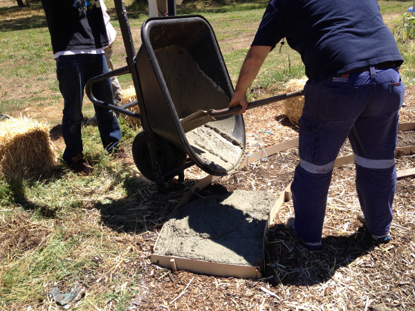 Pouring concrete for straw bale seat footing